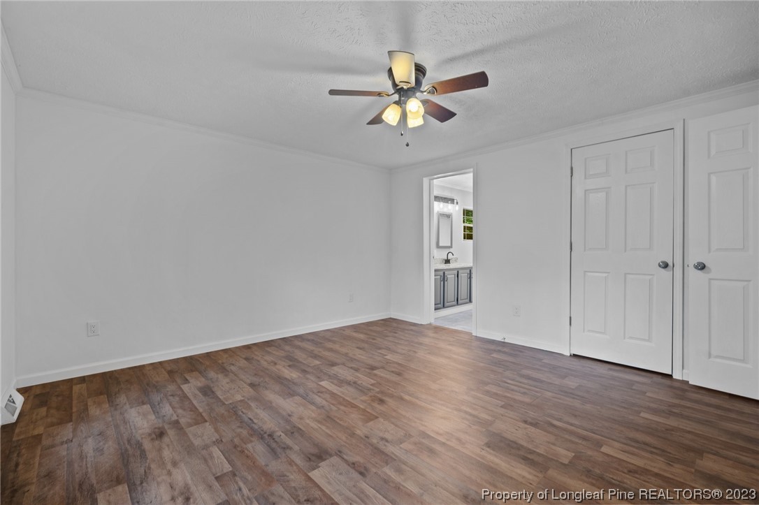 287 Doyle Cox Road Sanford, NC 27330 - Photo 8 of 35 a view of an empty room with wooden floor and a window