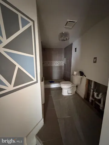 a bathroom with a toilet and a mirror