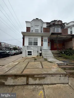 a front view of a house with car parked