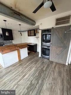 a view of kitchen with microwave and cabinets