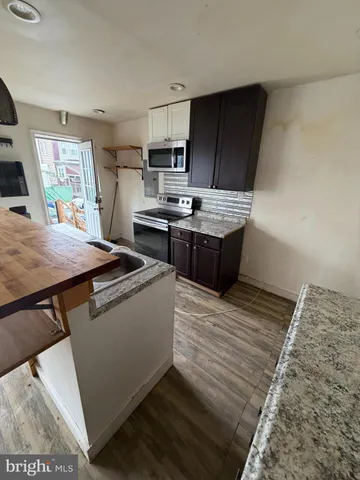 a kitchen with a stove and a refrigerator
