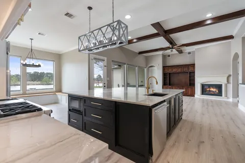 a bathroom with a granite countertop sink a toilet and a mirror
