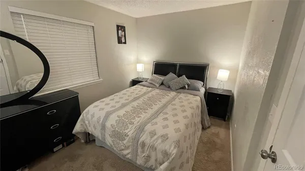a bedroom with a bed and a mirror