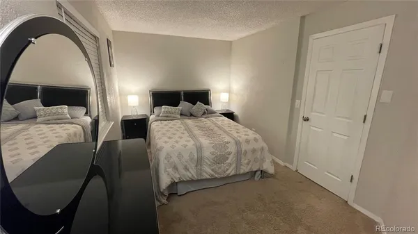 a bathroom with a toilet a sink a mirror and vanity