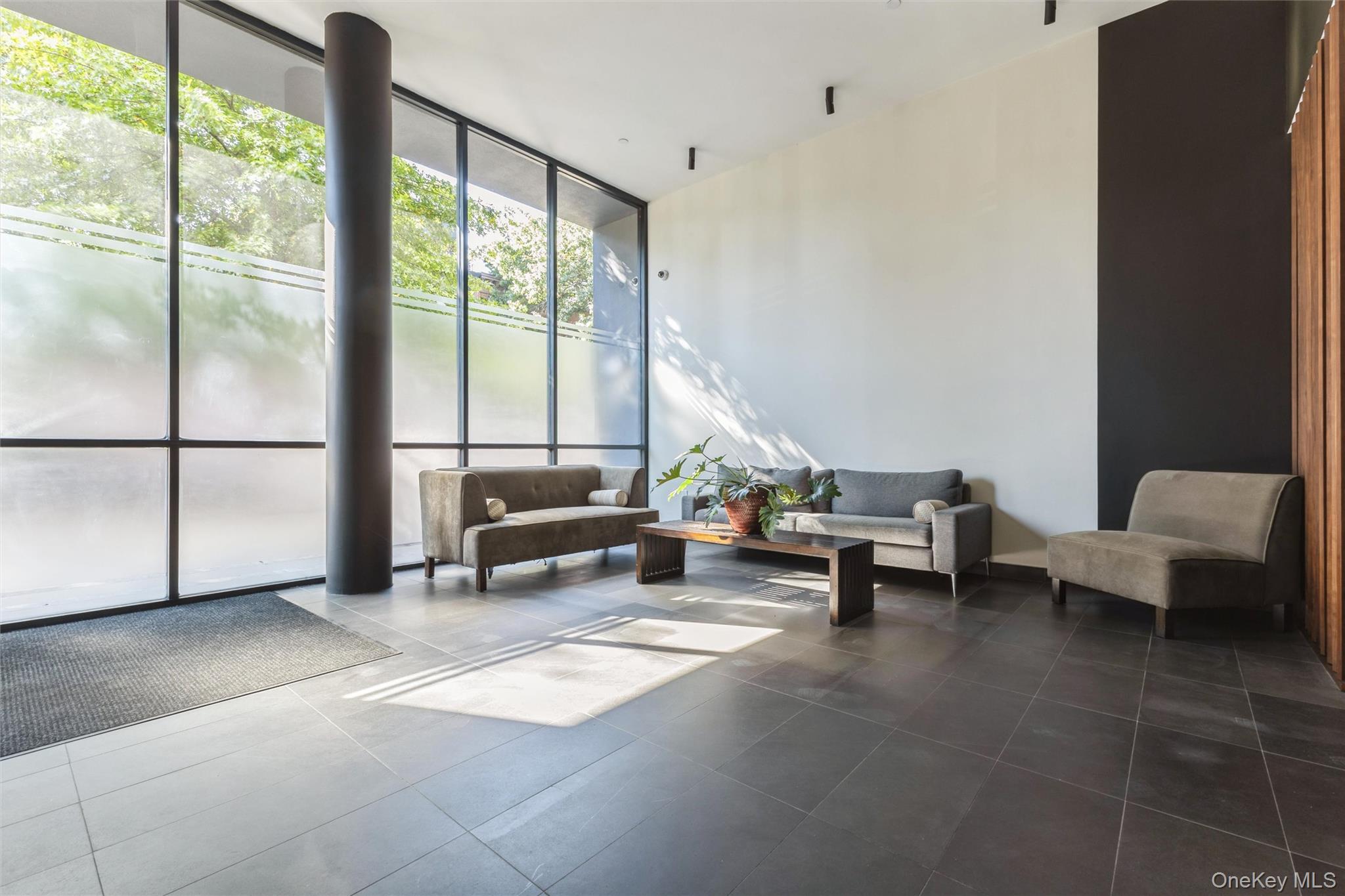 111 Monroe Street, Unit 4F Brooklyn, NY 11216 - Photo 21 of 25 Community lobby with a wall of windows