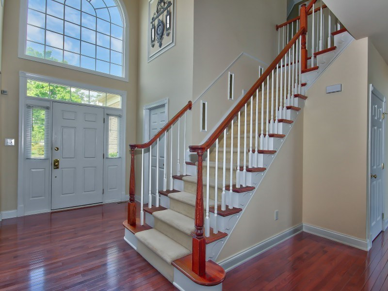 9612 Heathermill Lane Raleigh, NC 27617 - Photo 2 of 25 a view of entryway with wooden floor and stairs