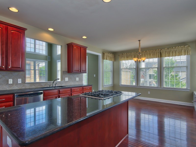 9612 Heathermill Lane Raleigh, NC 27617 - Photo 7 of 25 a kitchen with stainless steel appliances granite countertop a stove a sink and a microwave