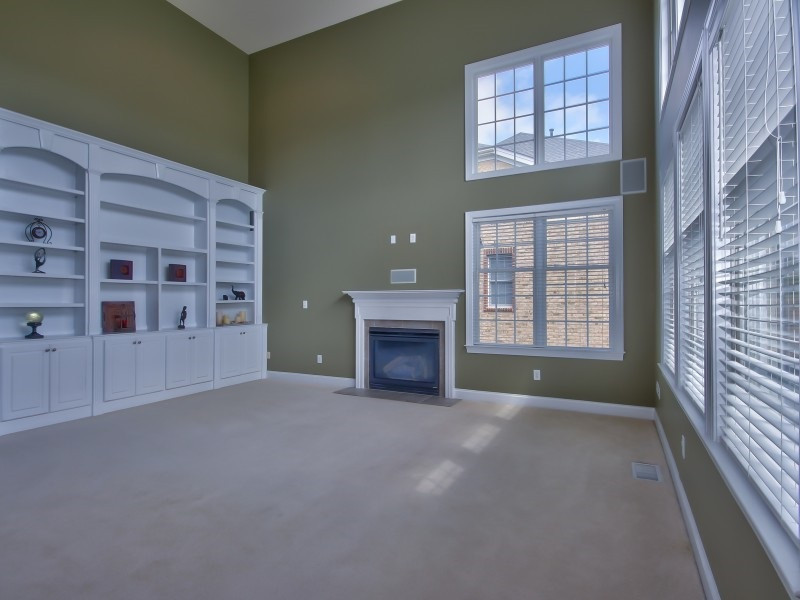9612 Heathermill Lane Raleigh, NC 27617 - Photo 10 of 25 a view of an empty room with a window and fireplace
