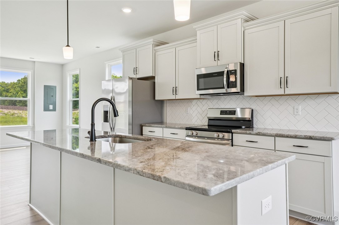 329 Mt Mccauley Way Aylett, VA 23009 - Photo 2 of 50 a kitchen with stainless steel appliances granite countertop a sink a microwave and cabinets