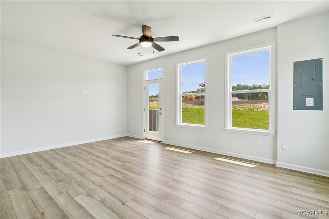 329 Mt Mccauley Way Aylett, VA 23009 - Photo 4 of 50 a view of empty room with wooden floor and fan