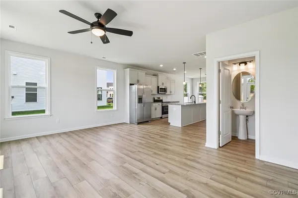 a view of a kitchen with a refrigerator a microwave oven a sink and a refrigerator