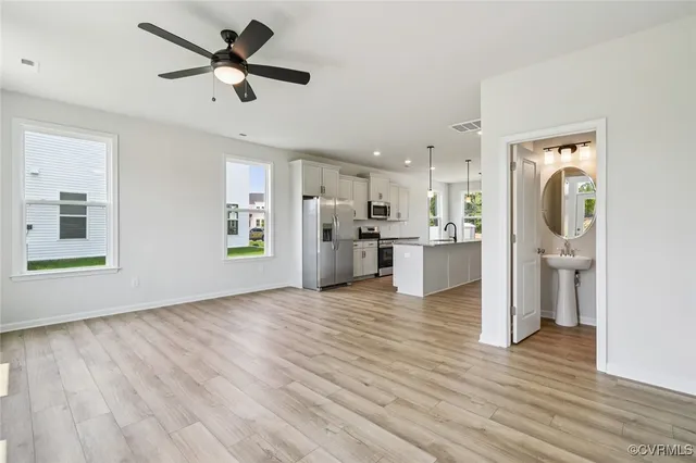 a view of a kitchen with a refrigerator a microwave oven a sink and a refrigerator