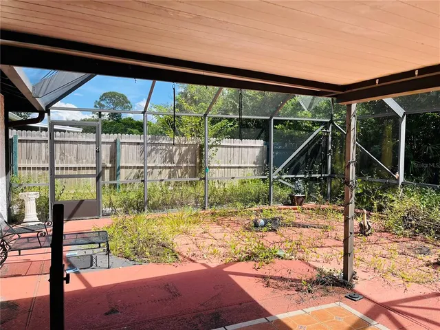 a view of patio with a table chairs and a floor to ceiling window