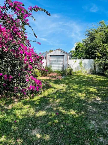 a view of a house with swimming pool and a yard