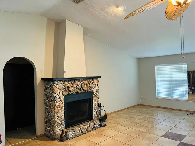 a view of empty room with window and fireplace
