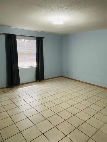 a view of an empty room and a window