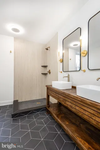 a bathroom with a double vanity sink and a mirror