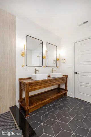 a bathroom with a double vanity sink and a mirror