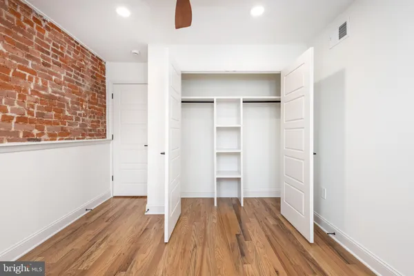 a view of a room with wooden floor and closet