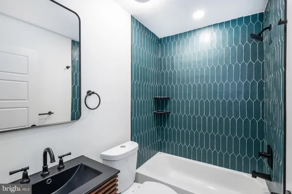 a bathroom with a toilet a sink and shower