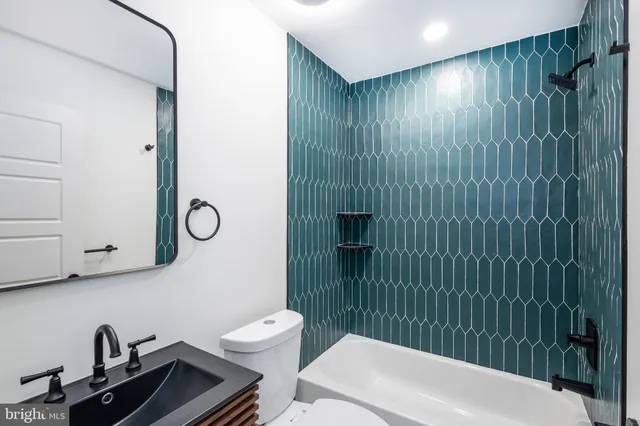 a bathroom with a toilet a sink and shower