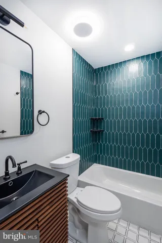 a bathroom with a sink a toilet and mirror