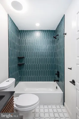 a bathroom with a toilet a sink and bathtub