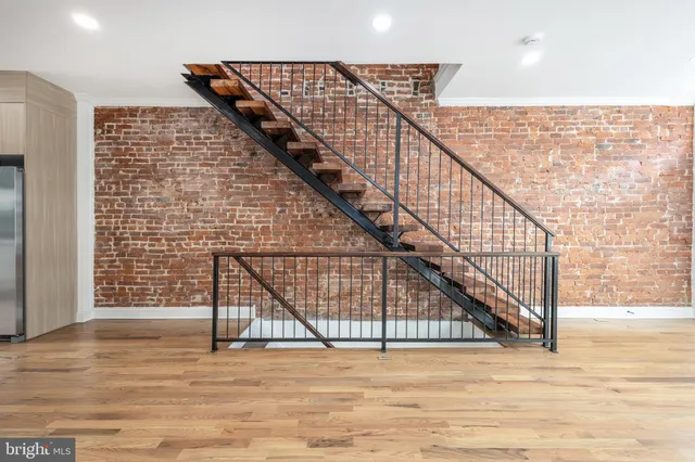 a view of staircase with white walls and railing