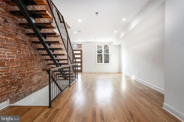 a kitchen with stainless steel appliances a stove top oven a refrigerator a sink and a cabinets