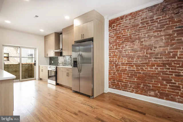 a kitchen with stainless steel appliances a refrigerator sink and cabinets