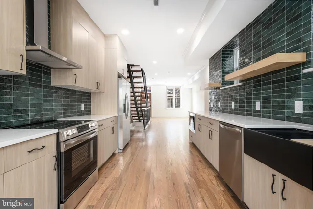 a kitchen with granite countertop a stove top oven and sink