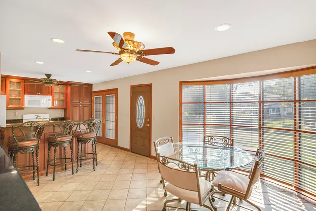 a dining room with furniture a chandelier and a rug