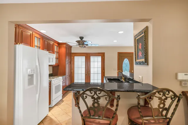 a kitchen with stainless steel appliances granite countertop a sink and cabinets