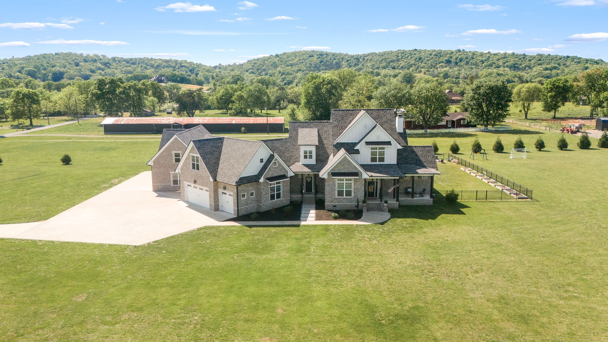 an aerial view of a house with a garden and a yard