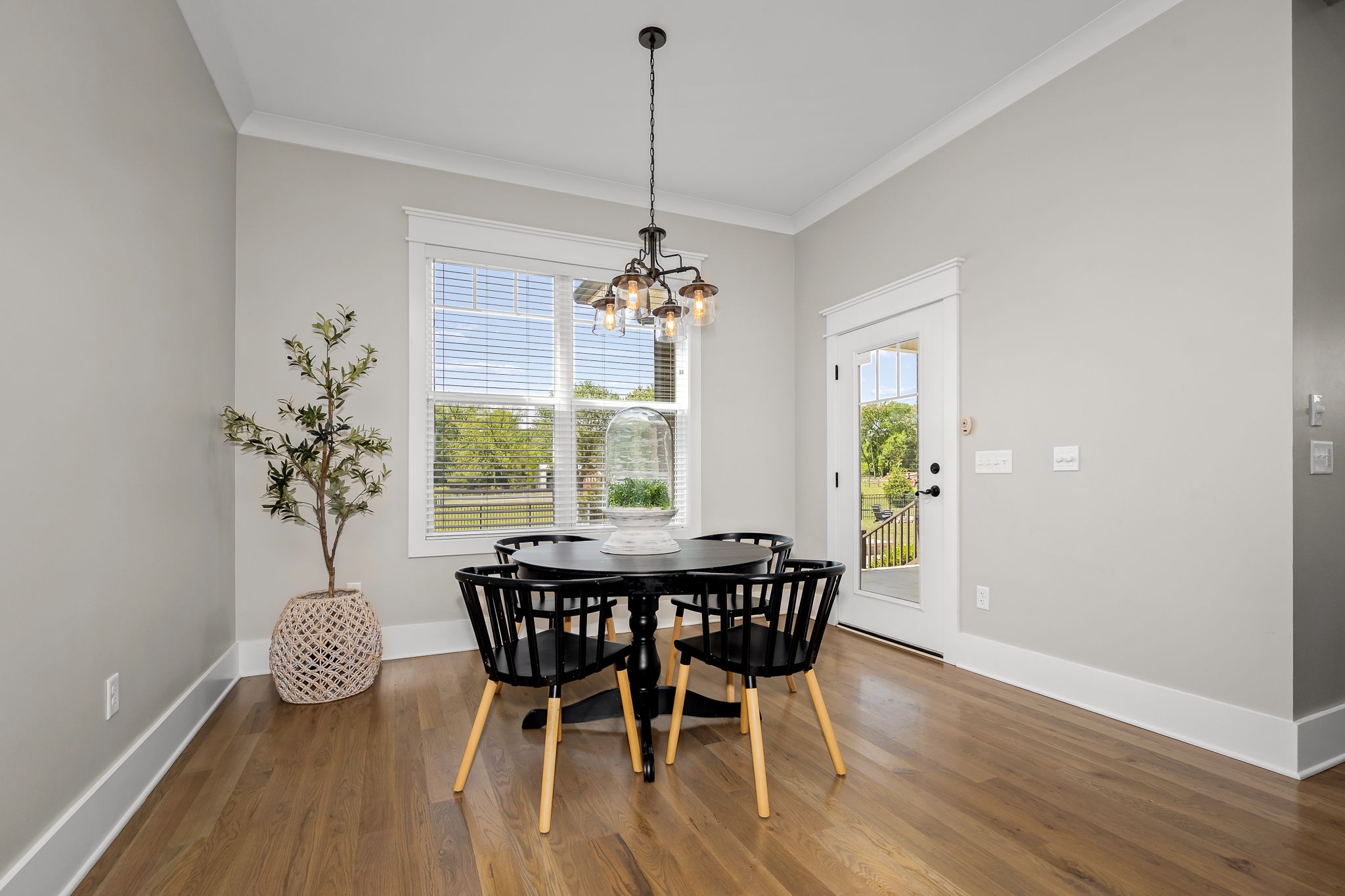 12365 Hogwood Road Milton, TN 37118 - Photo 17 of 59 a dining room with furniture a chandelier and wooden floor