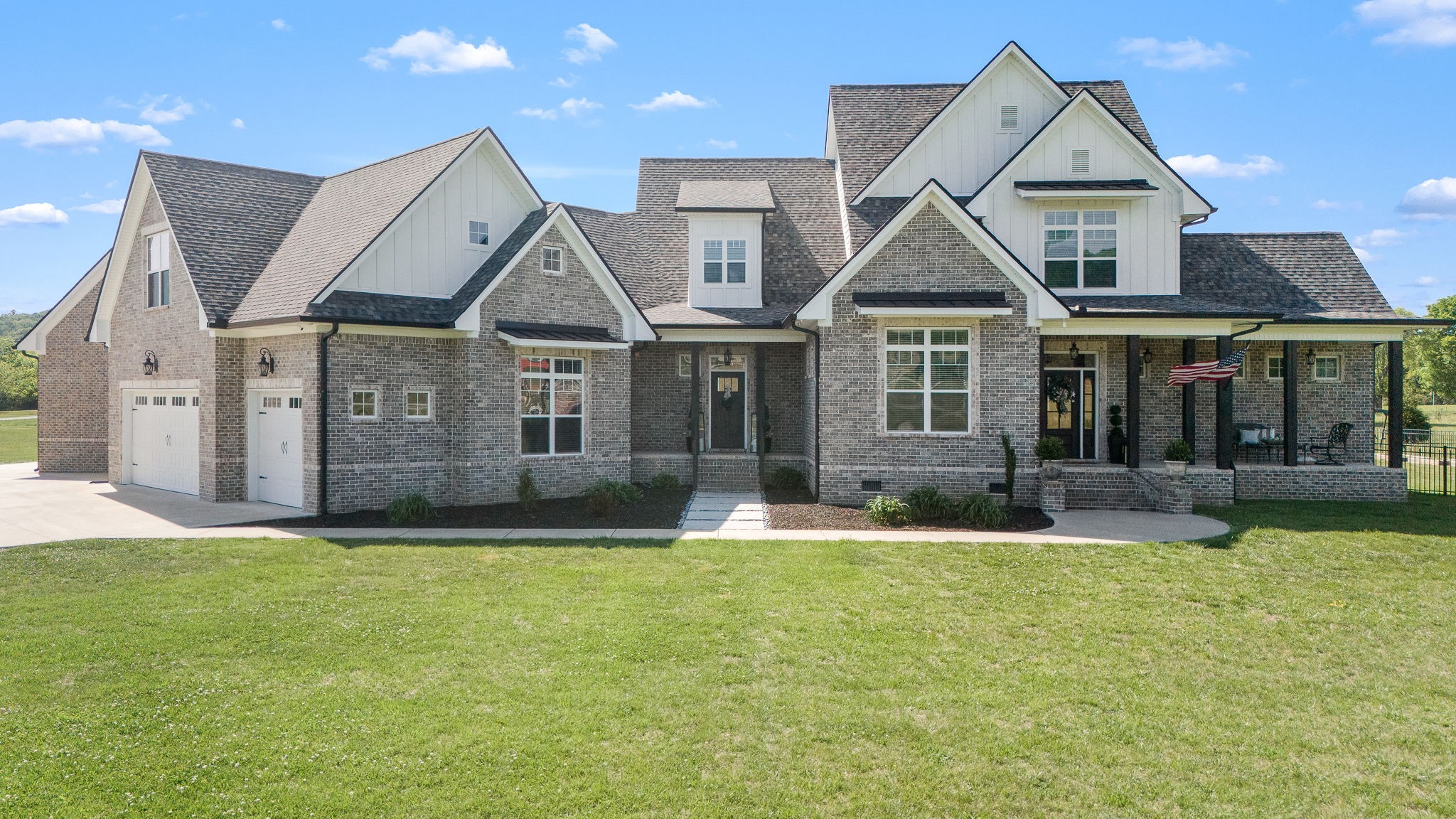 12365 Hogwood Road Milton, TN 37118 - Photo 4 of 59 a house with a big yard and potted plants in front of it