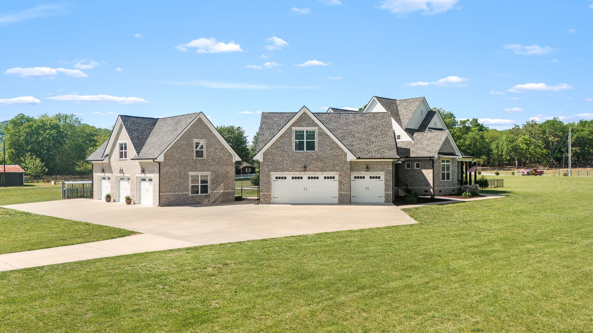 12365 Hogwood Road Milton, TN 37118 - Photo 57 of 59 a front view of a house with a big yard and palm trees
