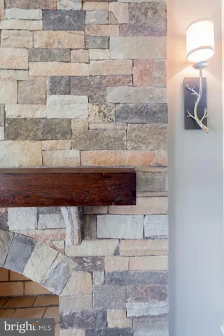 a living room with furniture fireplace and a large window