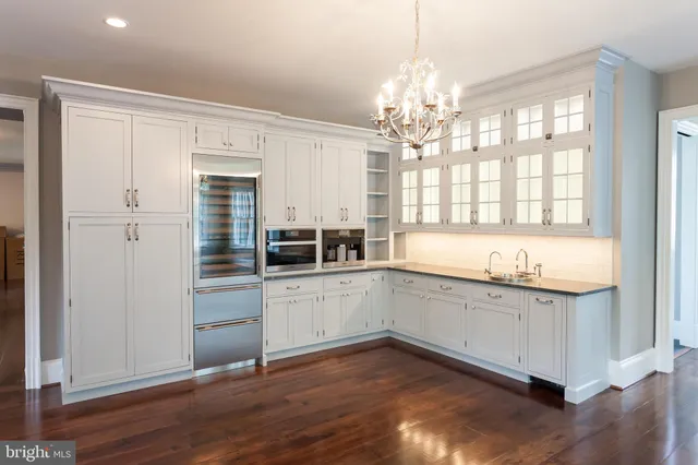 a bathroom with a sink mirror and a window