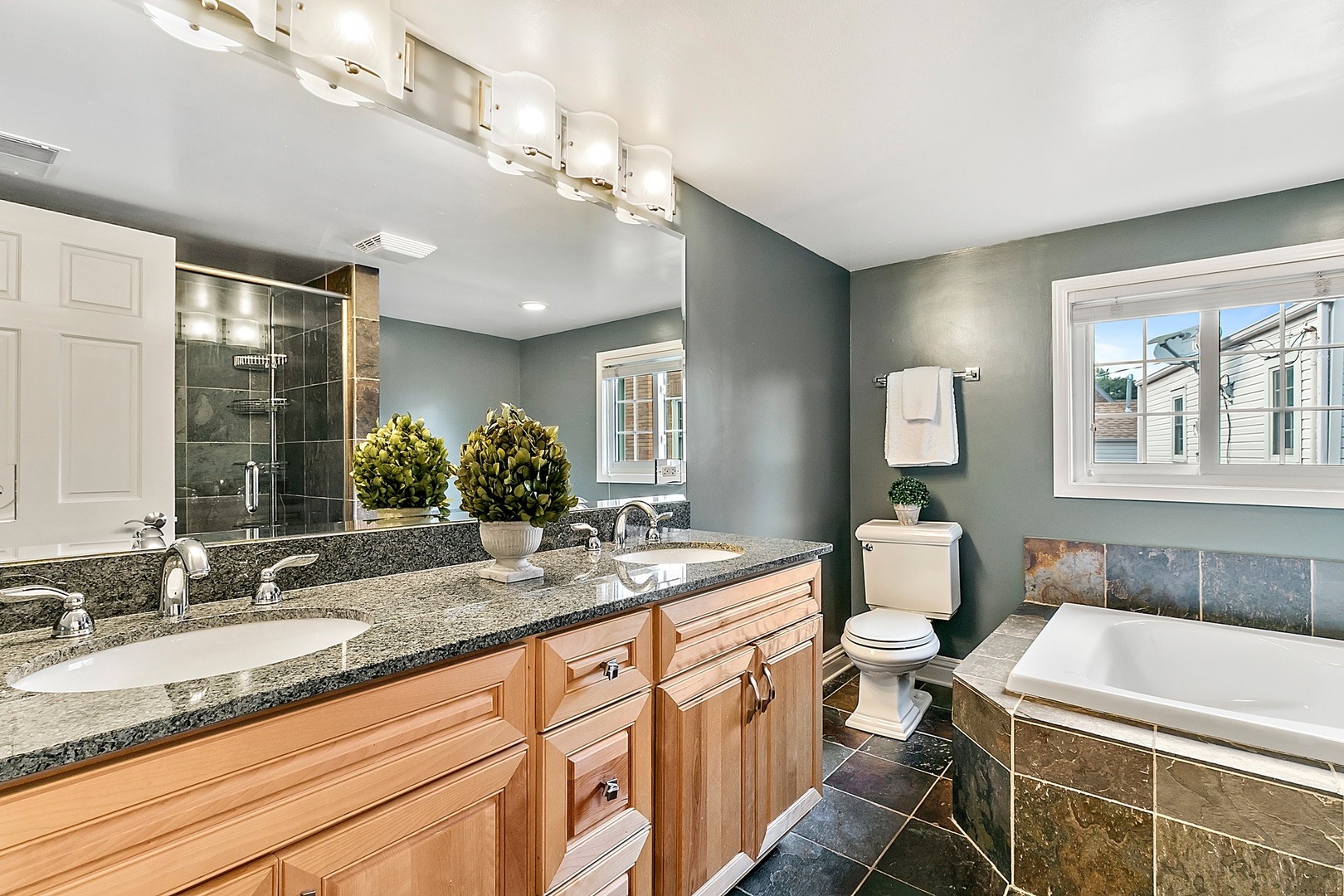595 Selborne Road Riverside, IL 60546 - Photo 13 of 25 a bathroom with a granite countertop sink mirror and bathtub