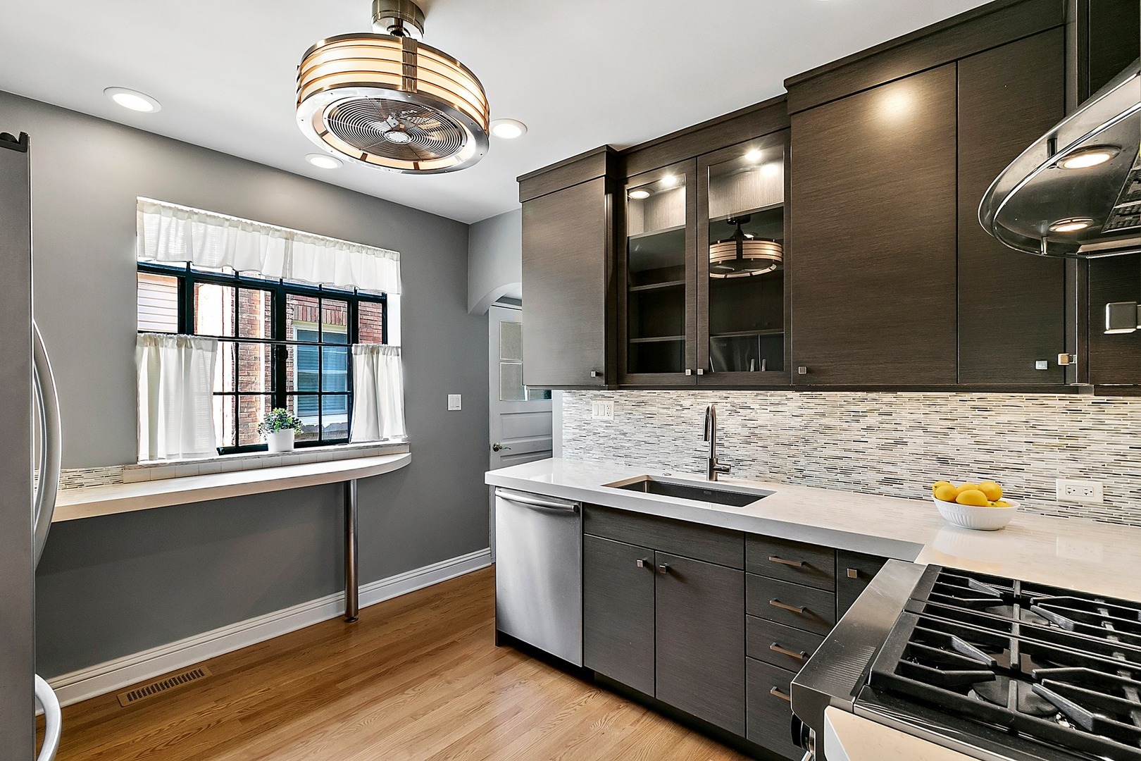 595 Selborne Road Riverside, IL 60546 - Photo 6 of 25 a kitchen with a sink and a stove top oven