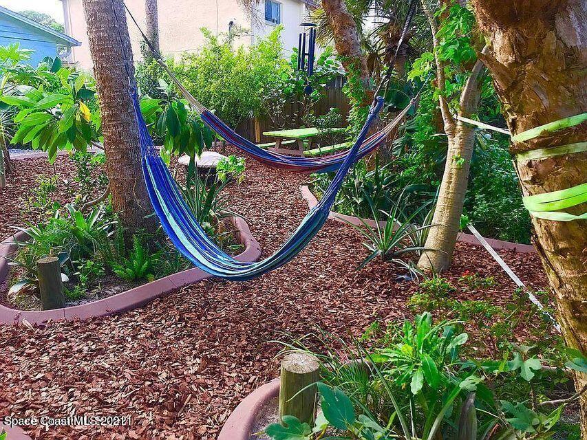 411 Audubon Drive Melbourne, FL 32901 - Photo 21 of 47 a view of a backyard with plants and a park