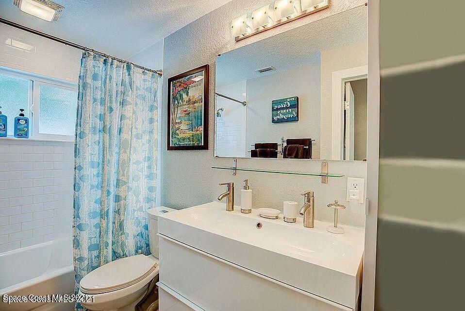 411 Audubon Drive Melbourne, FL 32901 - Photo 28 of 47 a bathroom with a sink a toilet and shower