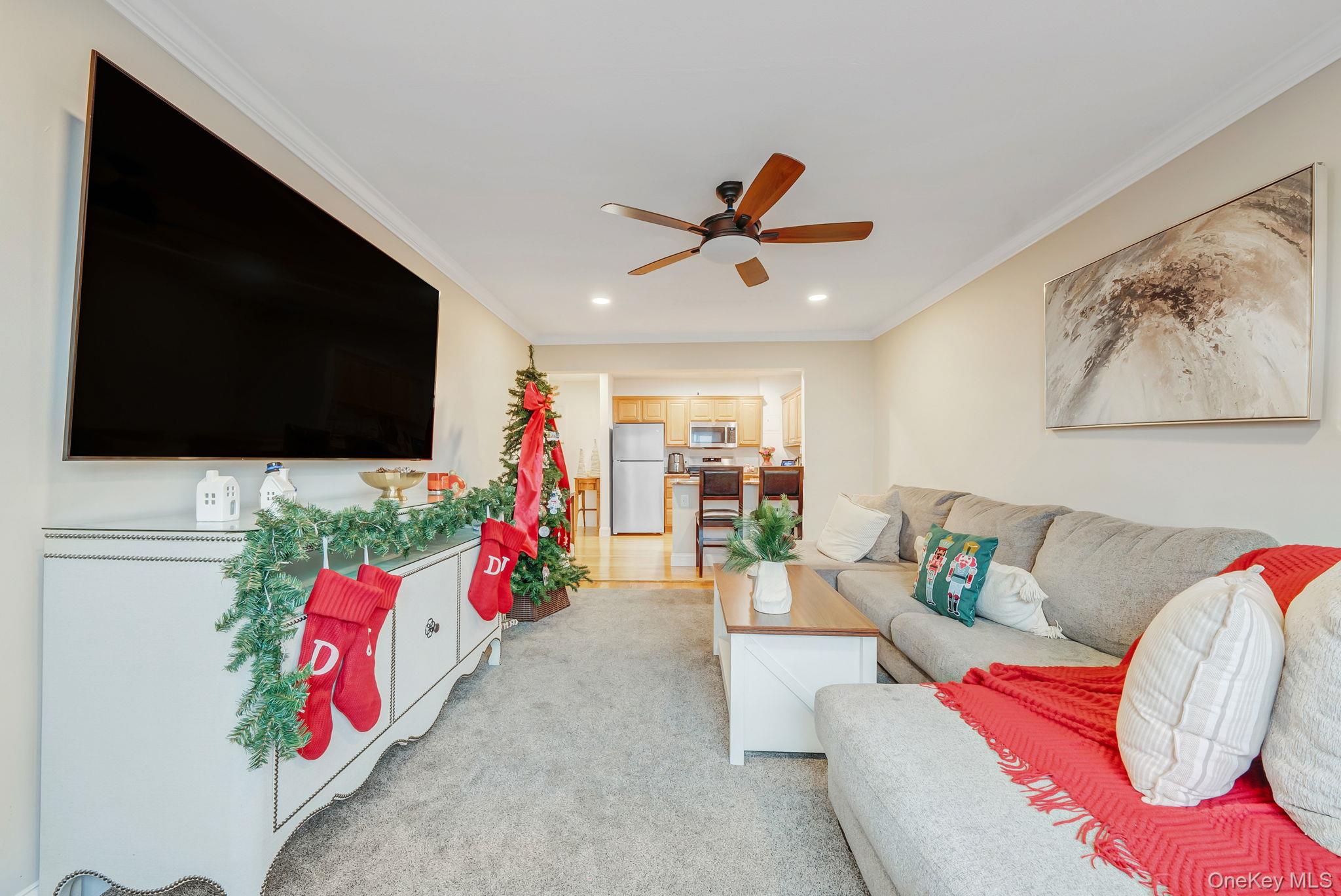 124 Smith Street, Unit 3F Freeport, NY 11520 - Photo 10 of 15 Living area with ornamental molding, a ceiling fan, recessed lighting, and light colored carpet