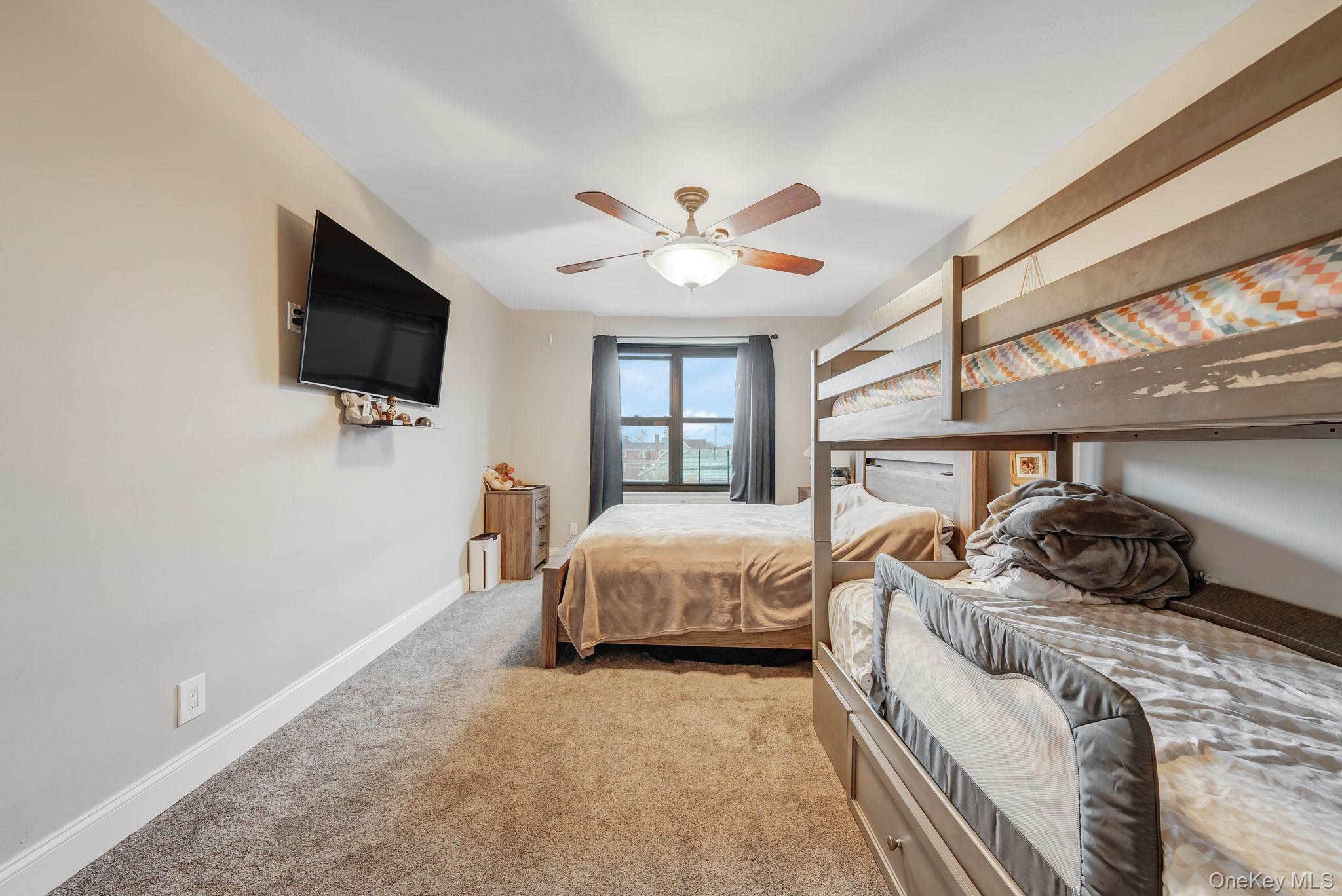 124 Smith Street, Unit 3F Freeport, NY 11520 - Photo 13 of 15 Bedroom with carpet floors and ceiling fan