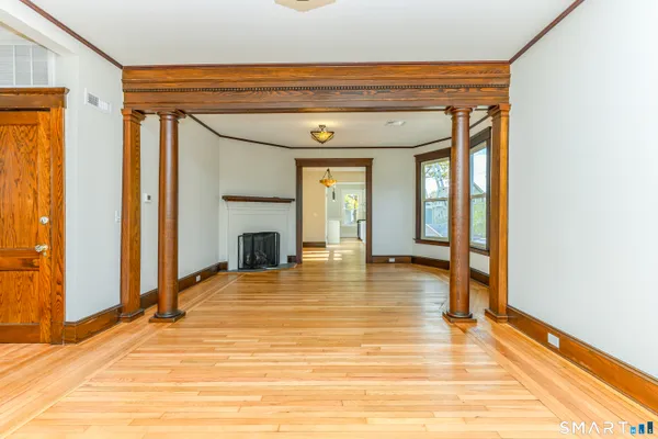 a view of a room with wooden floor and a window