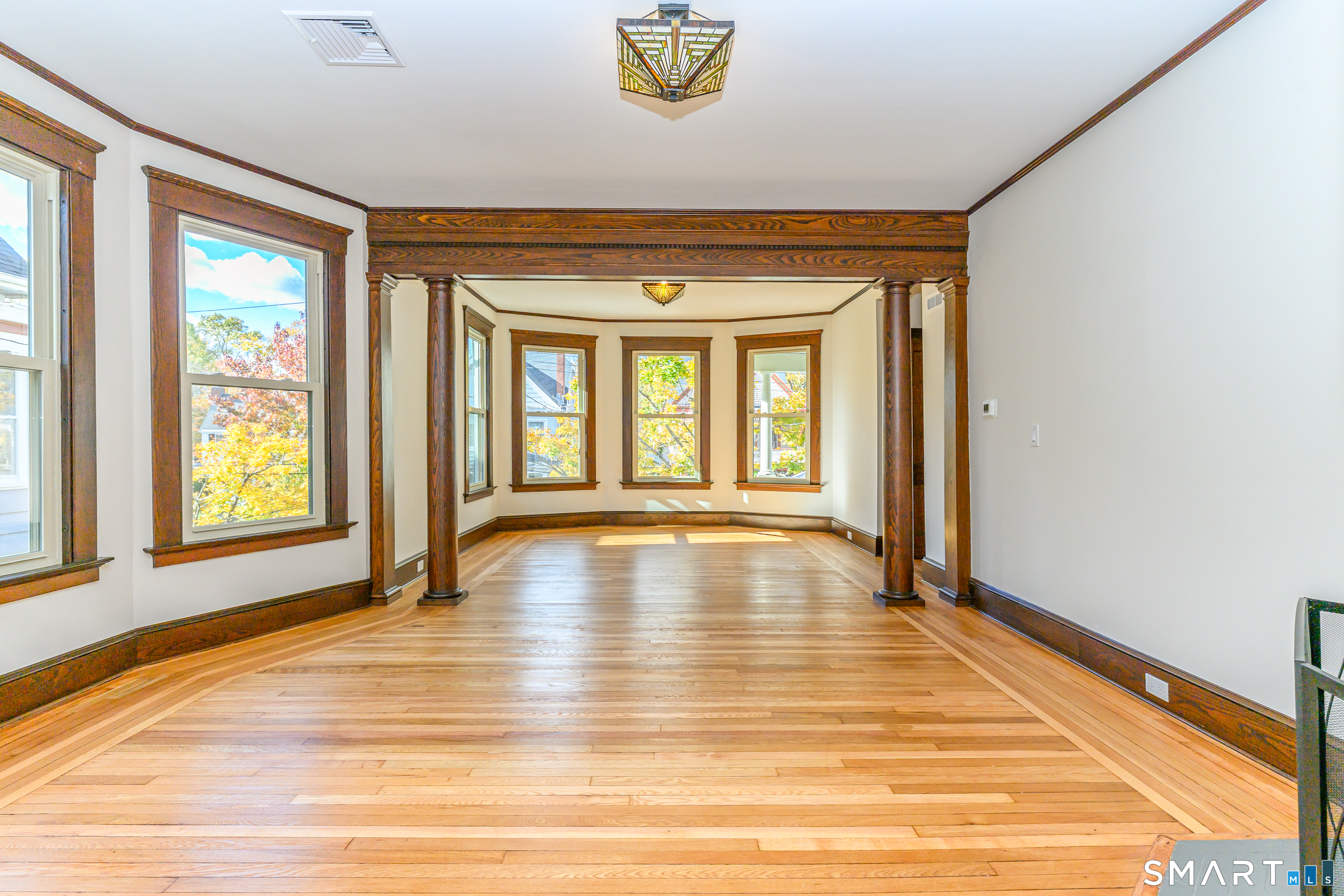 27 Hubinger Street, Unit 2 New Haven, CT 06511 - Photo 15 of 31 a view of an empty room with window and wooden floor