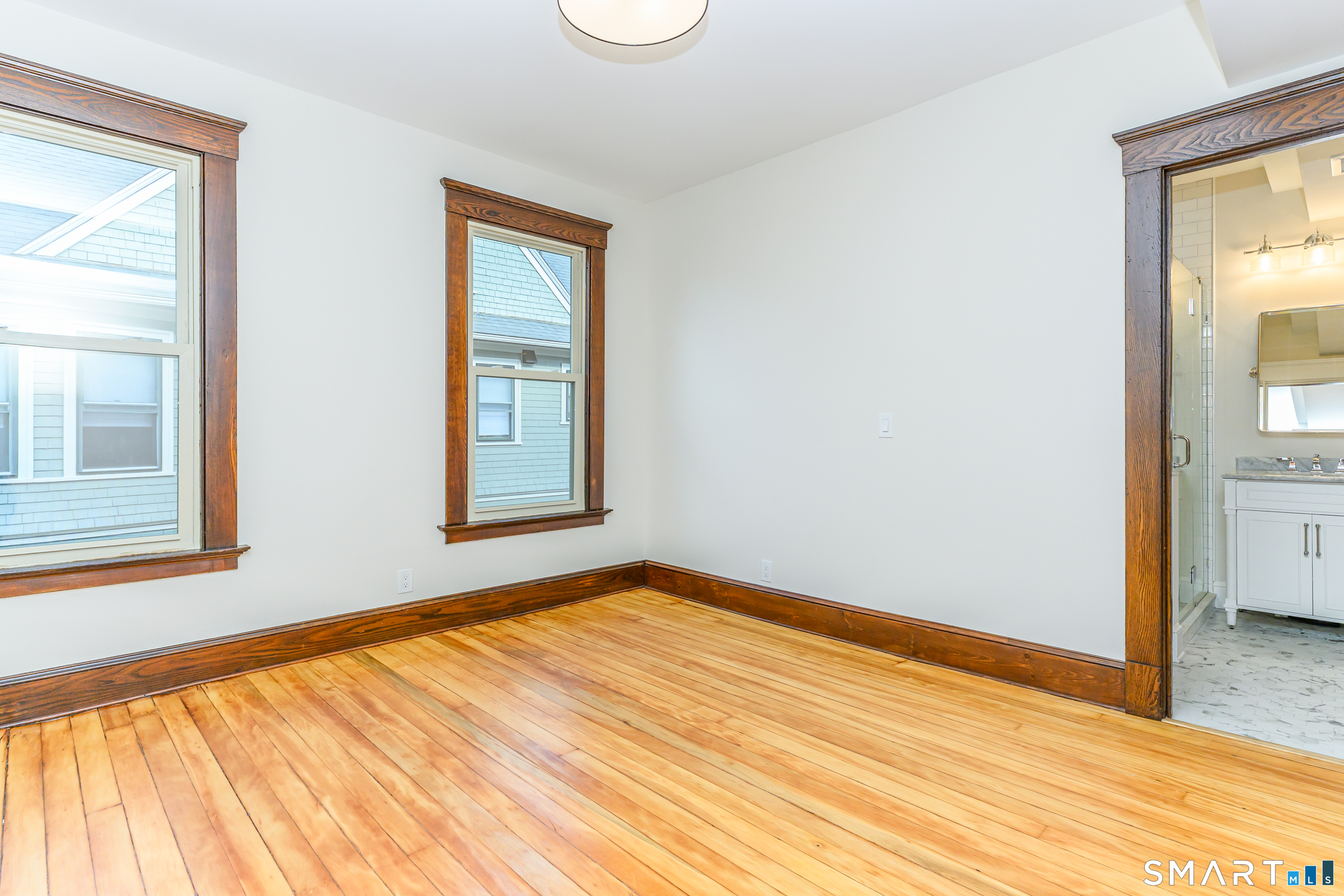 27 Hubinger Street, Unit 2 New Haven, CT 06511 - Photo 24 of 31 a view of an empty room with wooden floor and a window
