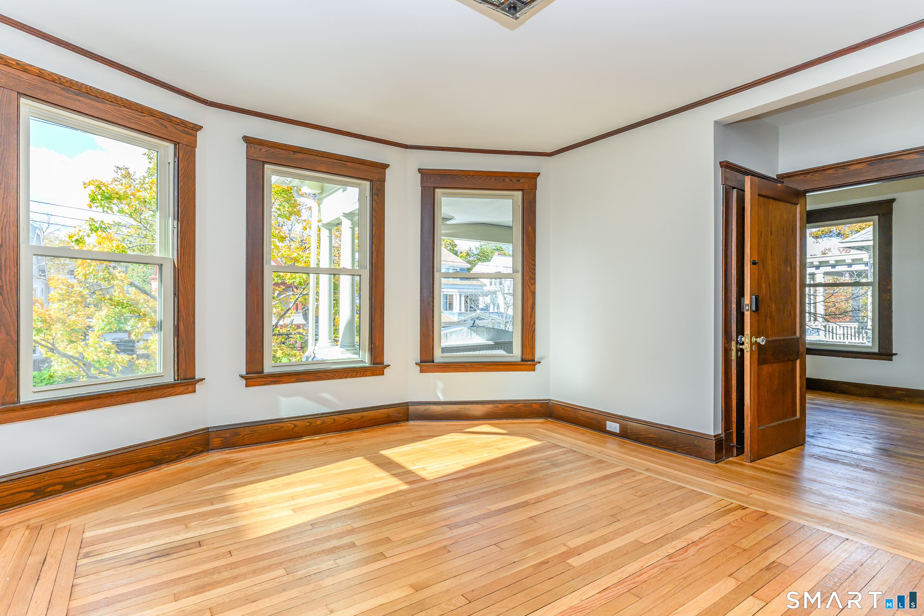 27 Hubinger Street, Unit 2 New Haven, CT 06511 - Photo 9 of 31 a view of an empty room with wooden floor and a window