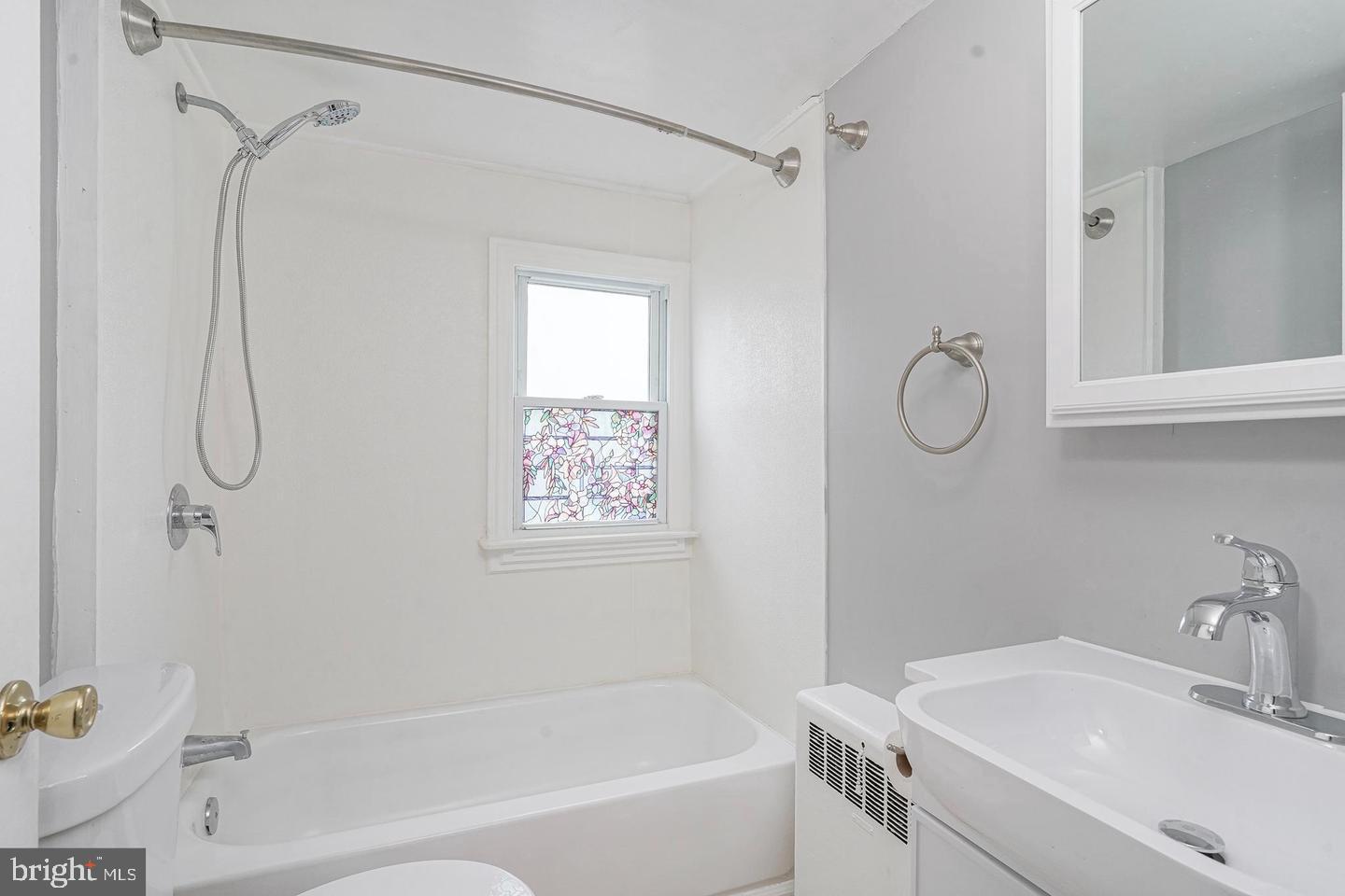 89 Main Street Bridgeport, NJ 08014 - Photo 14 of 15 a bathroom with a sink a mirror and a shower